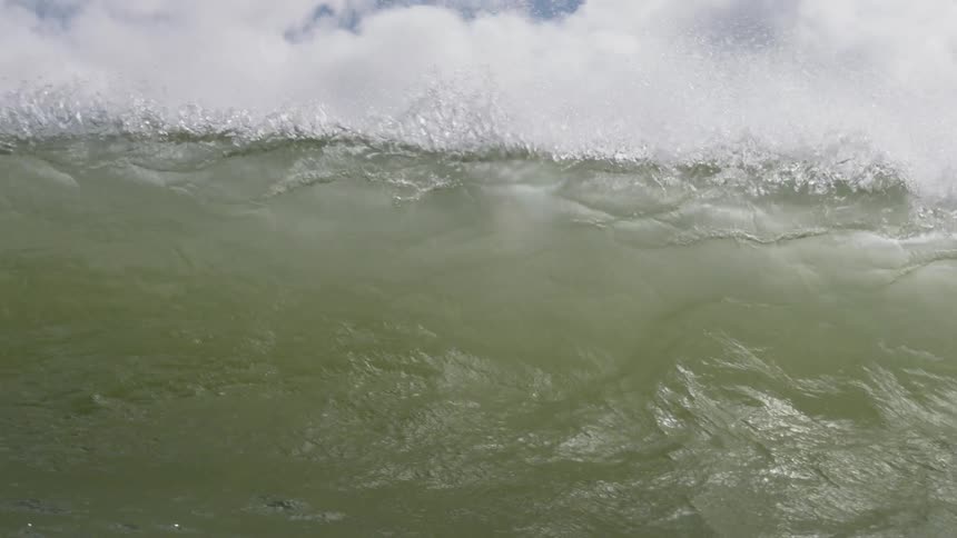 An ocean wave crashes down