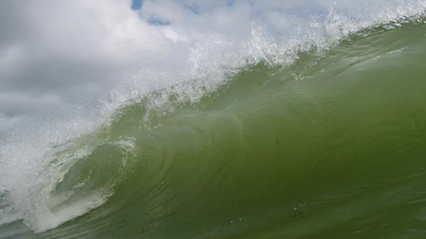 An ocean wave crashes down