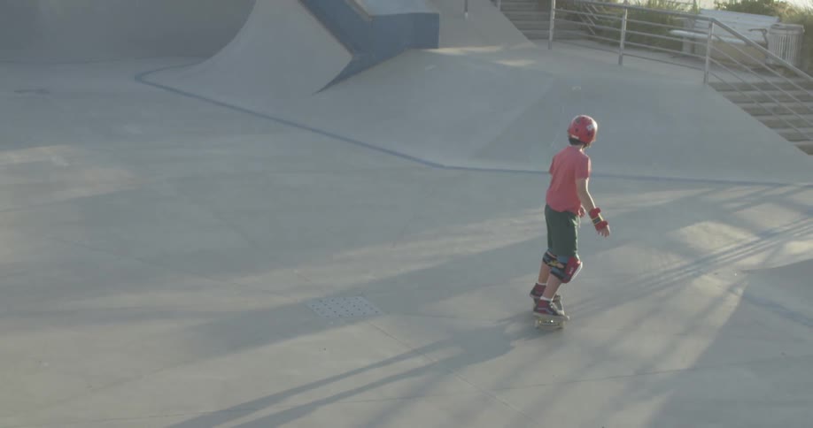 Child dropping down a ramp on a skateboard