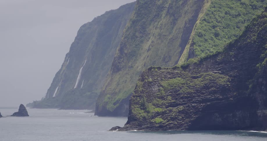 Ocean crashes against rugged steep coastline