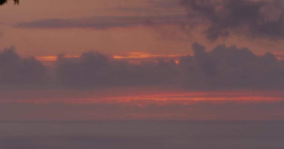 The sky is orange as the sun goes down