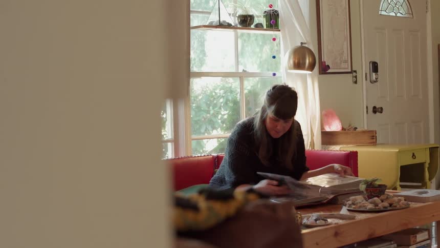 A woman looks through a photo album