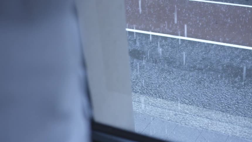 Raindrops falling on concrete