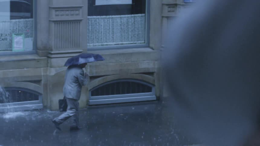 Raindrops falling on concrete