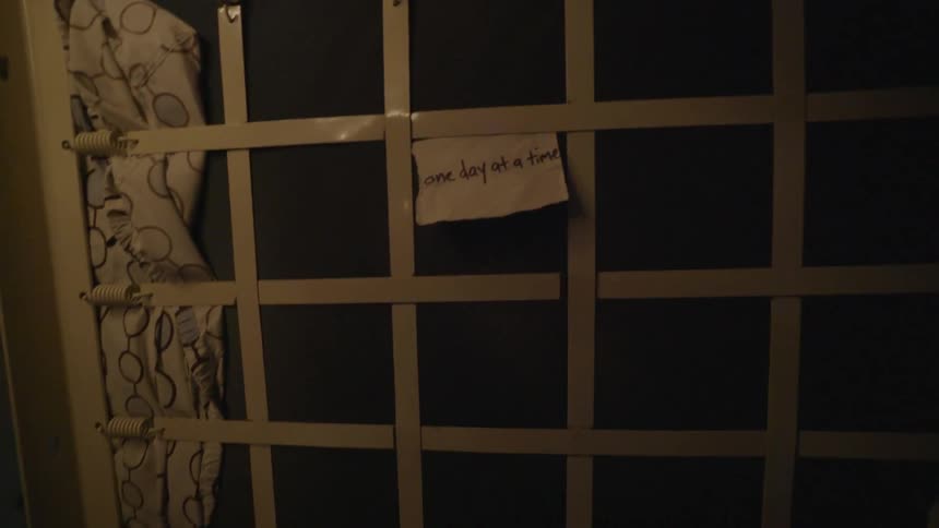 A note is posted on the underside of a bunk mattress
