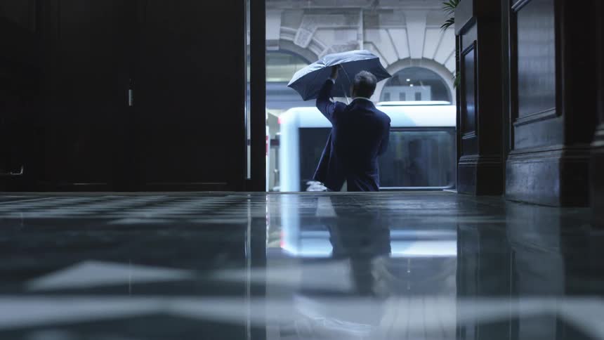 A person opening an umbrella