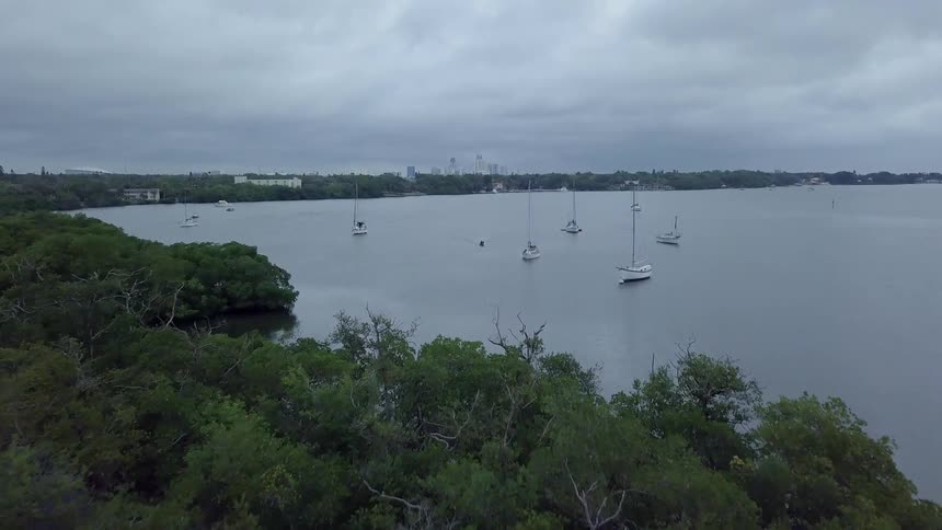 Boats float on the water under overcast skies