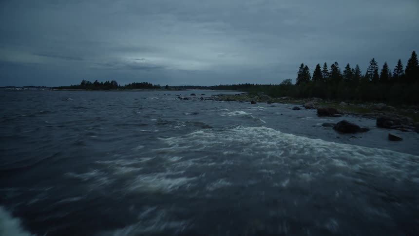 Waves are crashing along a rocky shore