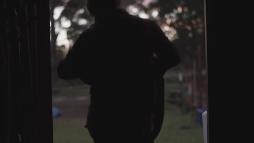 A person walking out of a door to go outside