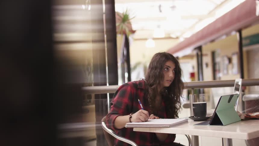A person sitting down to write something
