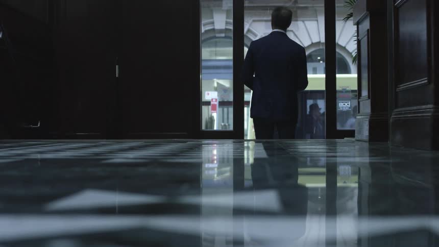 A person walking out of a door to go outside