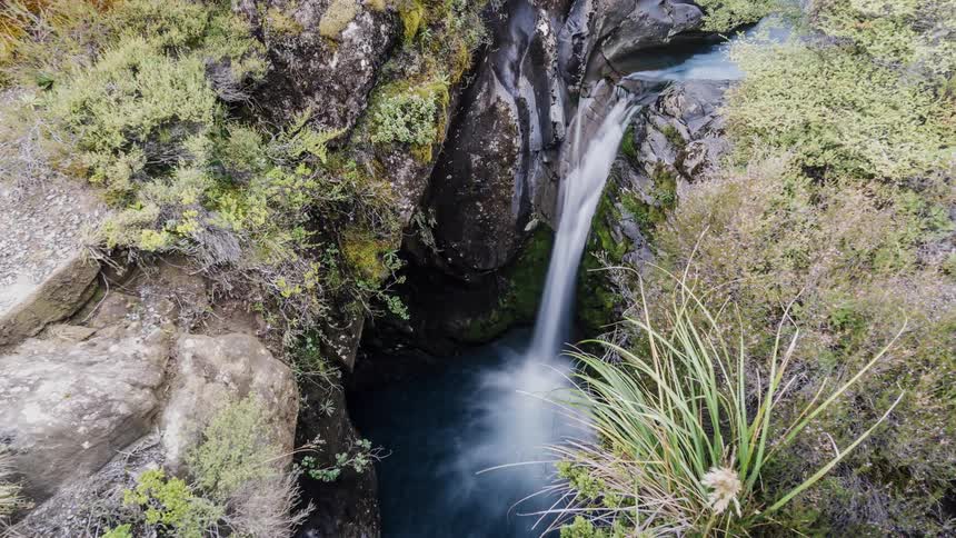 A waterfall flows over a cliff