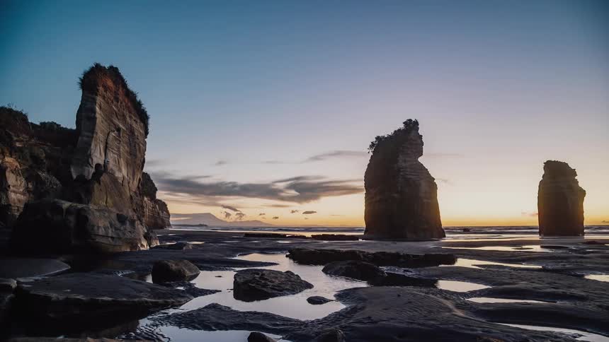 Ocean water washes ashore at sunset