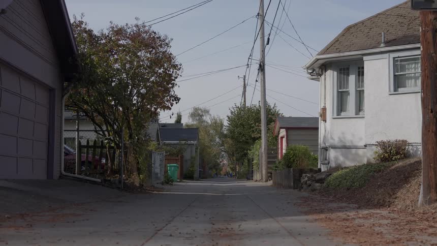 Power lines hang above a small town alleyway