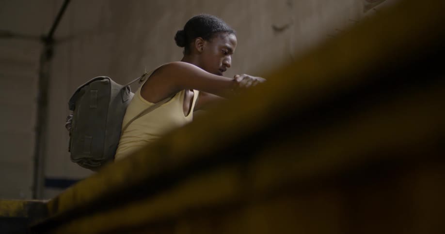 A woman sits on the ground looking sad