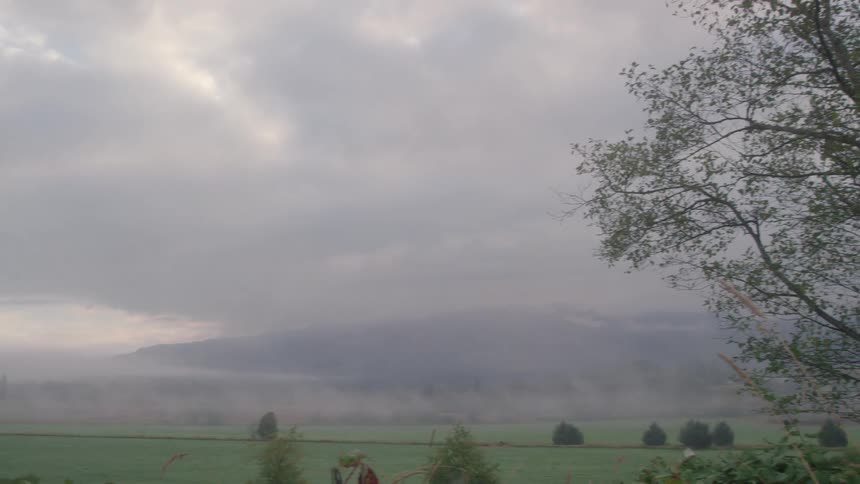 Clouds float over a rural field