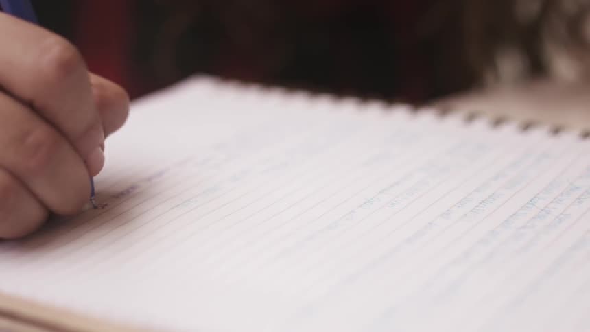 A person writing on paper