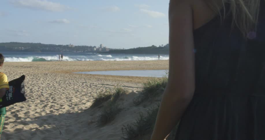 A person walking down to the beach