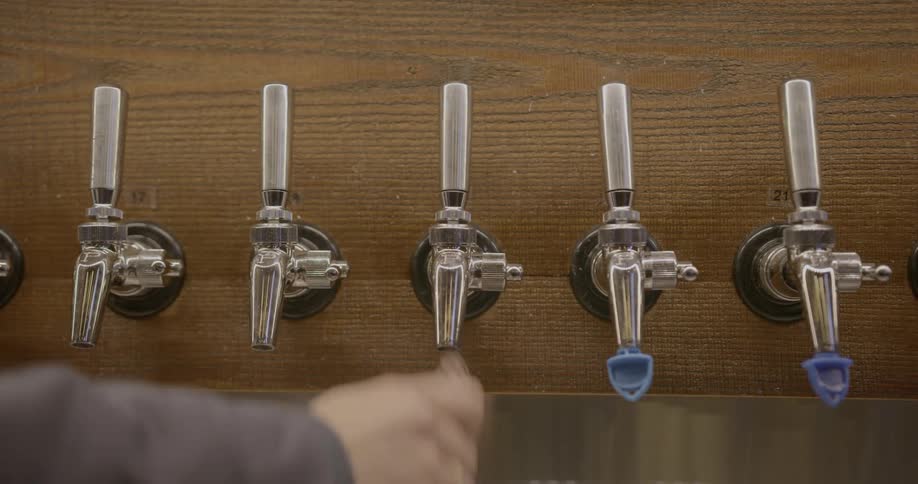 Covers are removed from beer taps in a bar