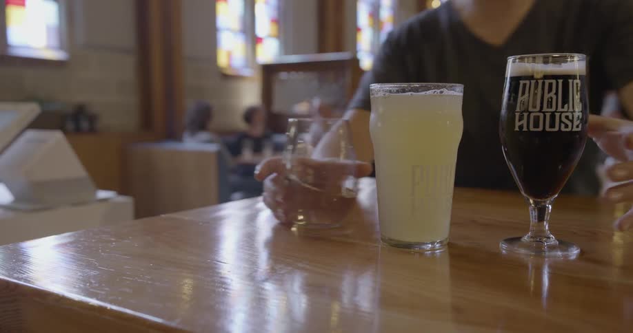A person places drinks on a counter