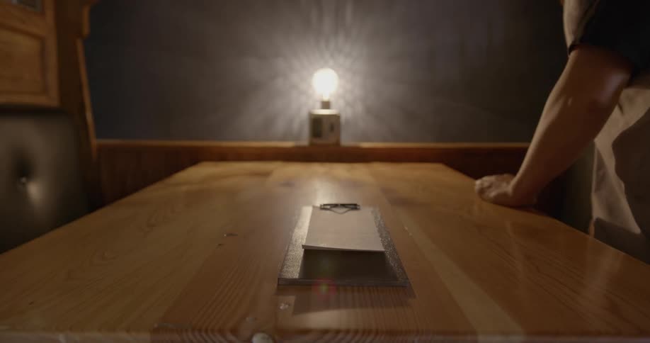 Man turns on a light in a restaurant booth