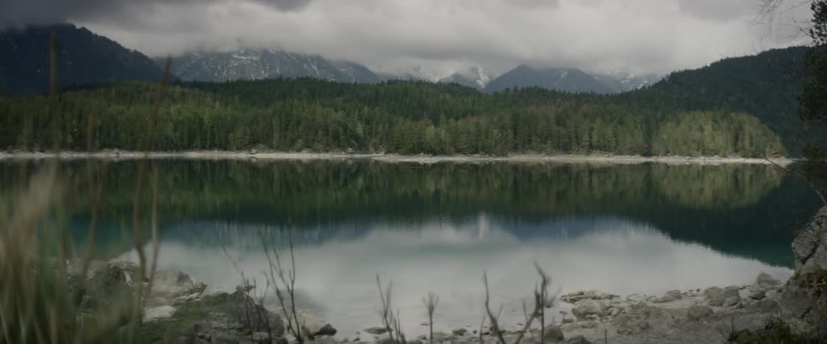 Clouds float over a mountain lake