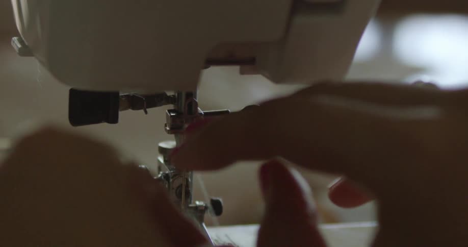 A person using a sewing machine