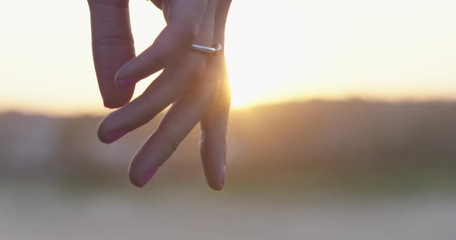 A person wearing a ring outside