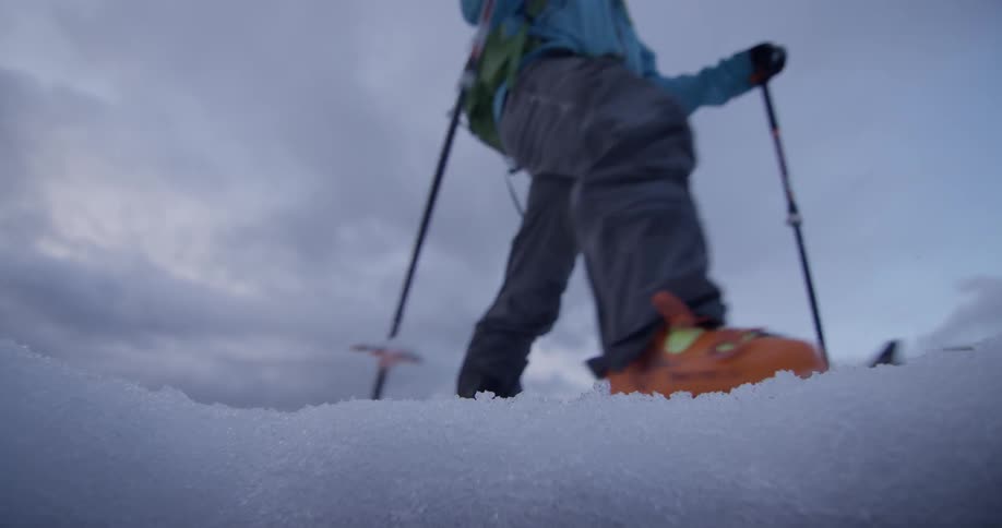 Someone is hiking on a snow covered mountain