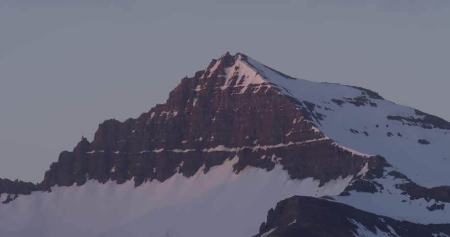 Snow covered mountain at sunset