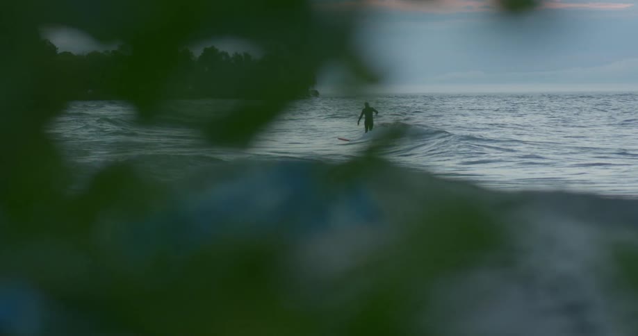 A person surfing on a cloudy day