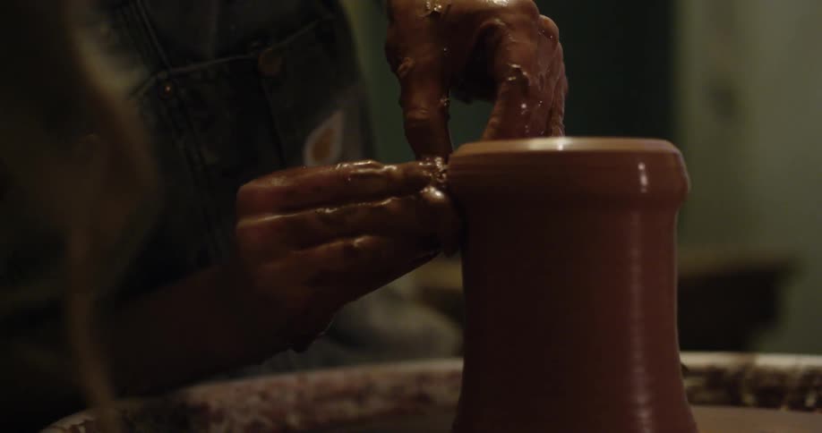 A person is creating something on a pottery wheel