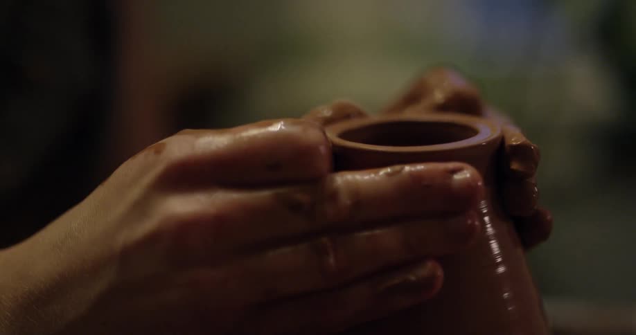 A potter molding a vase