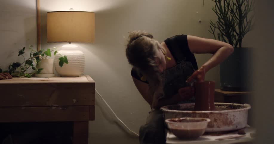 A woman spinning a vase