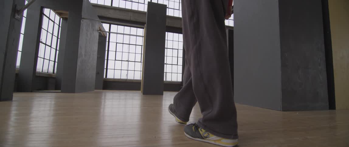 Close up of legs walking on a hardwood floor