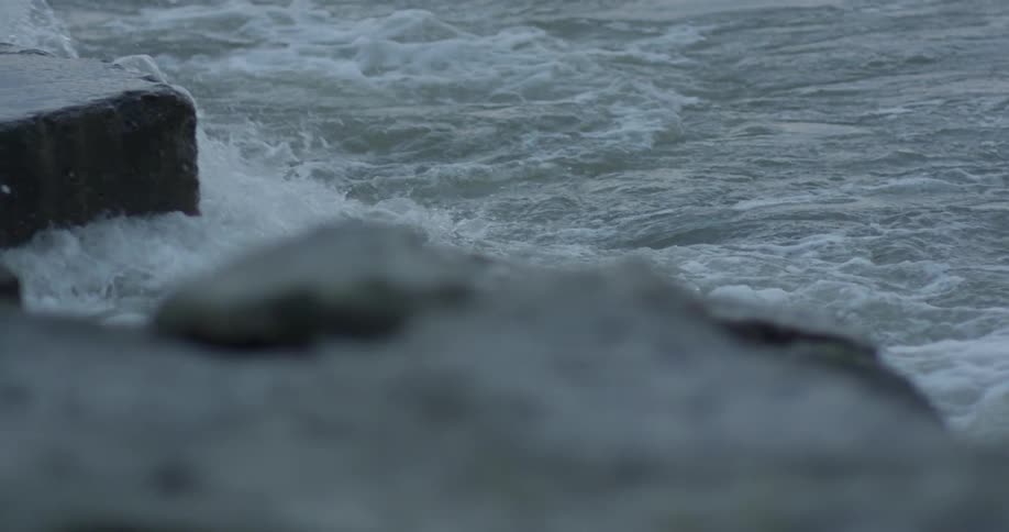 Ocean waves crash into rocks