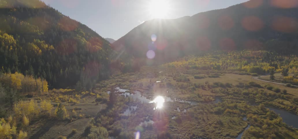 Sunlight shines over a mountain lake