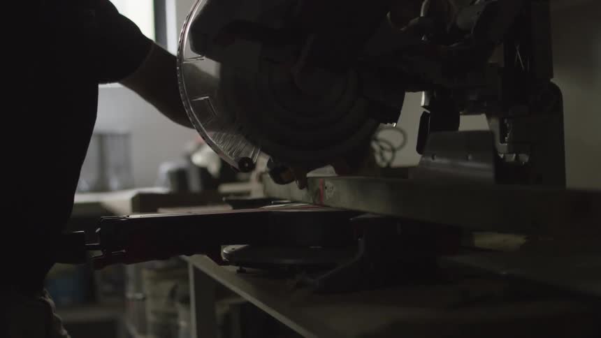 Man using a miter saw to cut wood