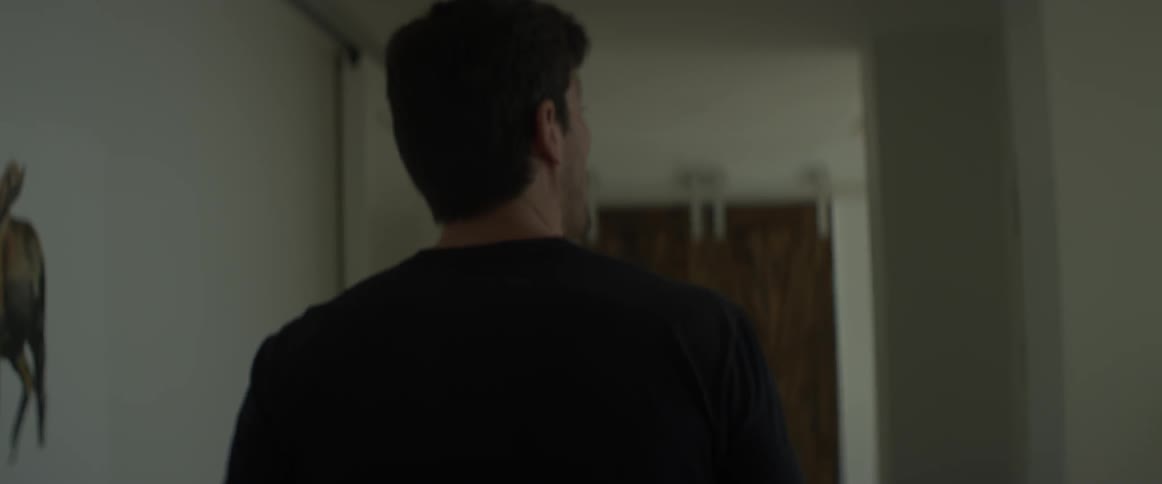 Man walks down a hallway