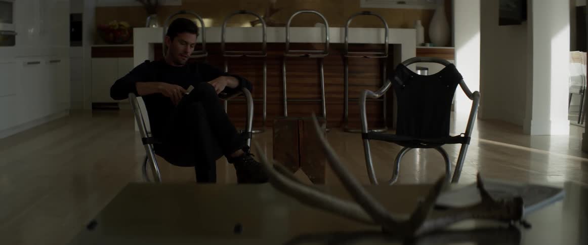 A man sits in a chair with a book