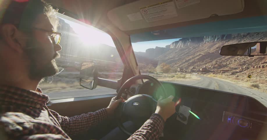 A man drives through the desert and talks