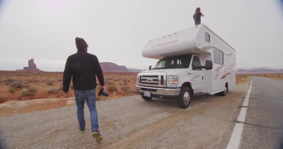 A person walking towards a rv