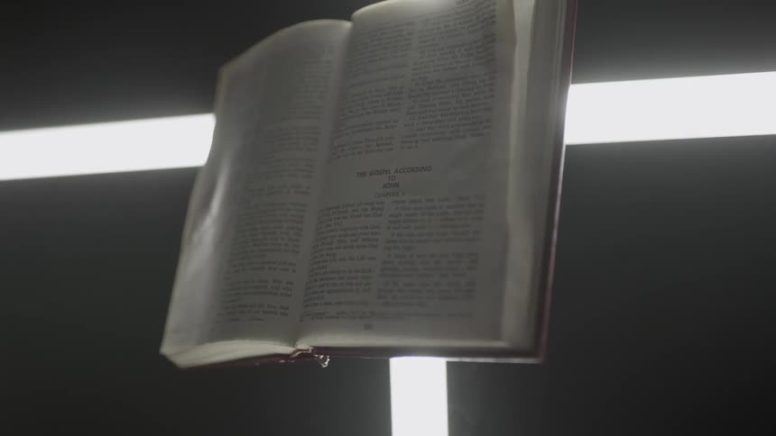 Lights shine behind a Bible