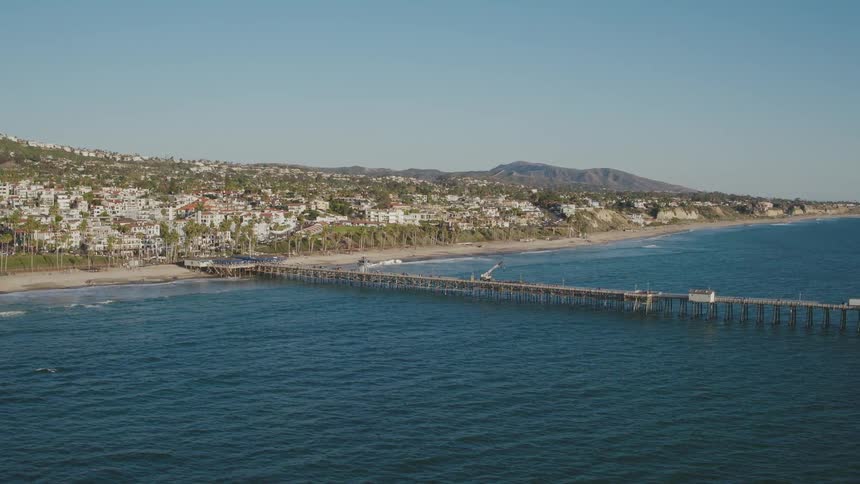 A wooden pier goes deep into the ocean