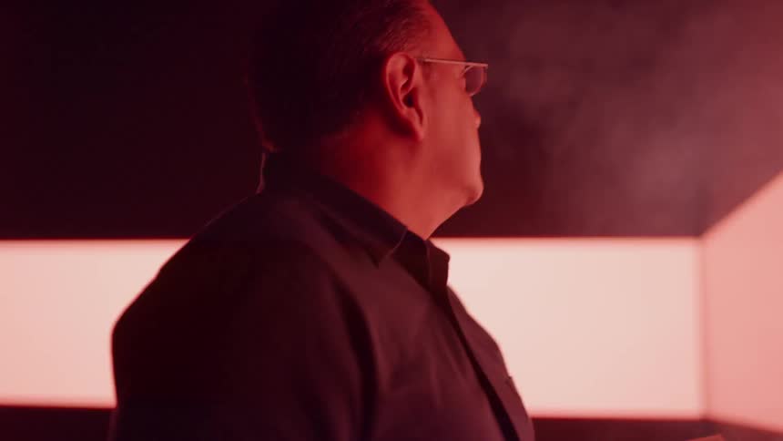 Man looking at a book in front of LED wall