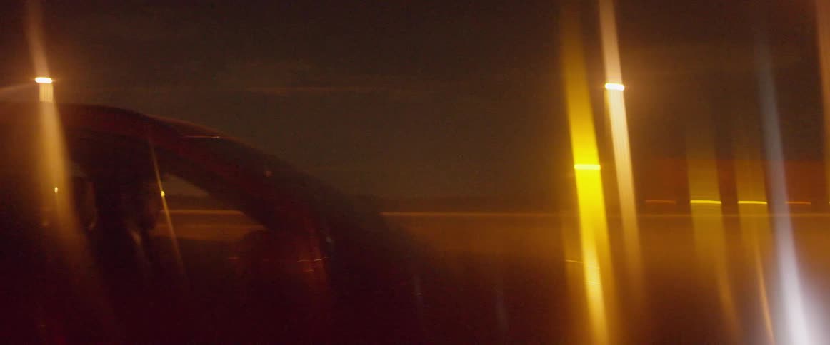 A car travels on a road at night