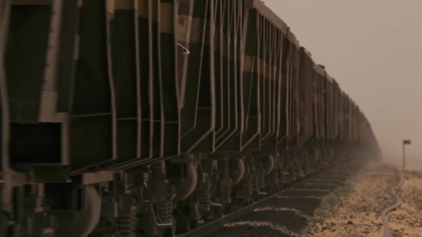 A train passing through a dusty area