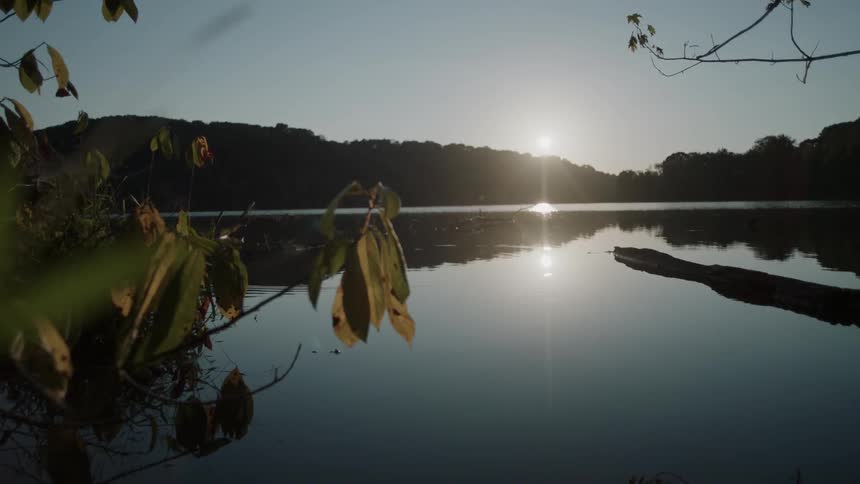 The sun sets over a mountain lake