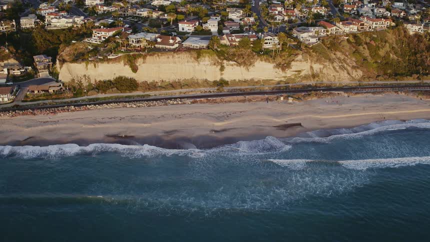 The blue waters move along the shore below