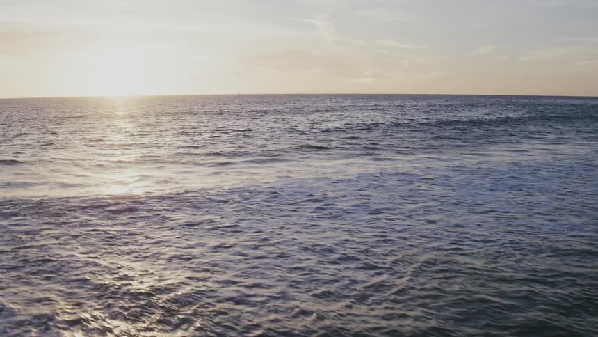 The sun sets over an ocean